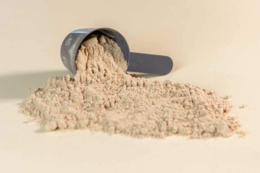 Close-up of raw chicken meat and calcium carbonate powder on a kitchen scale